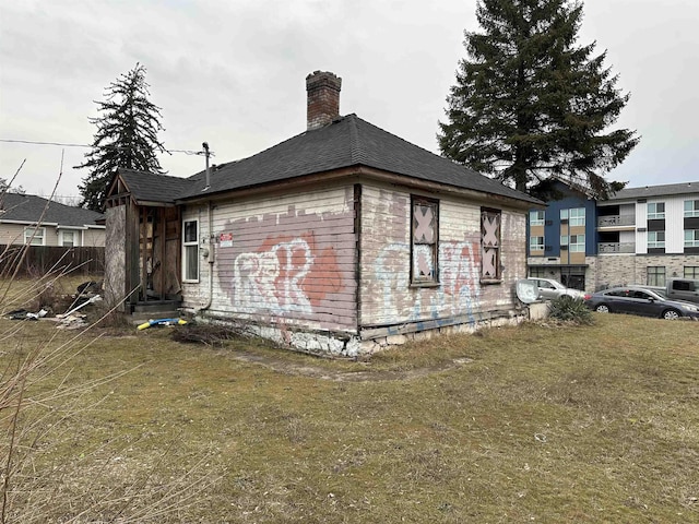 2803 N Hamilton St, Spokane, WA 99207 - view of home's exterior with a chimney and a yard