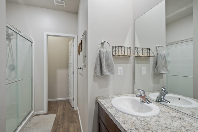 bathroom with vanity, wood-type flooring, and a shower with shower door