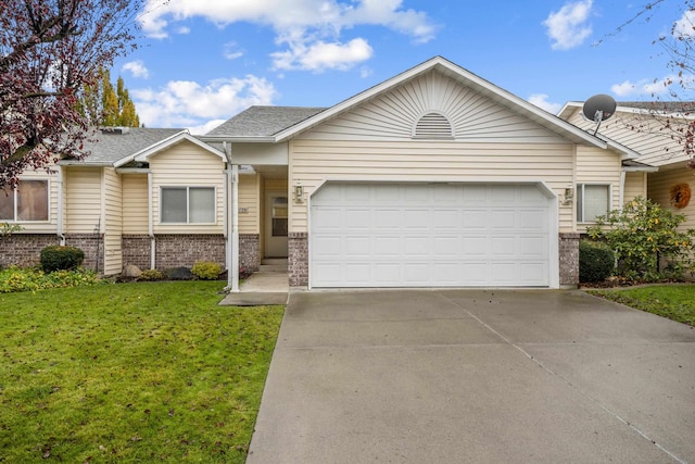 single story home with a garage and a front lawn