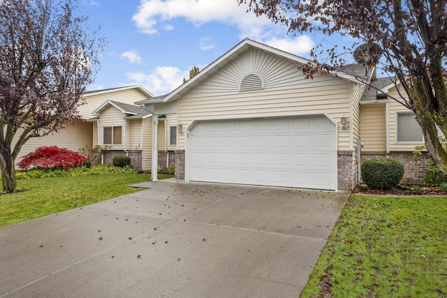 view of front of house featuring a garage and a front lawn