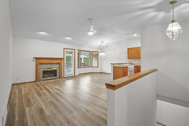 unfurnished living room with lofted ceiling and light wood-type flooring