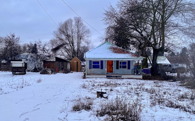 view of front of house with a storage shed