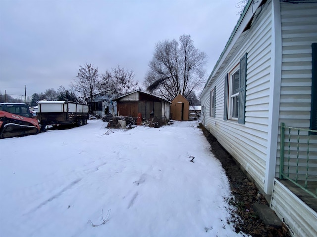 530 Kalmia St, Kettle Falls, WA 99141 - yard layered in snow featuring an outbuilding and a shed