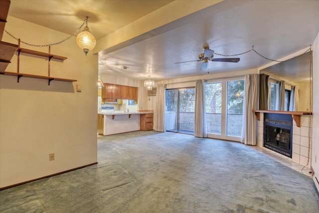 unfurnished living room with a fireplace, light carpet, and ceiling fan