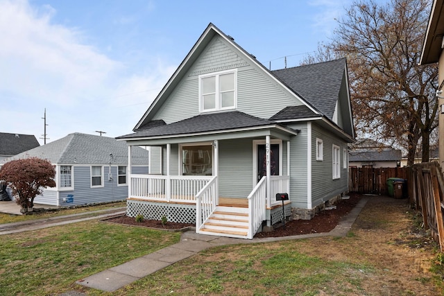 view of front facade with covered porch and a front yard