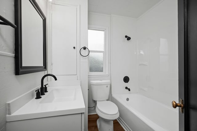 full bathroom featuring vanity, toilet, crown molding, and bathtub / shower combination