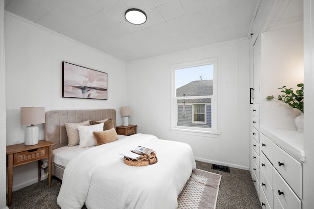 carpeted bedroom featuring crown molding