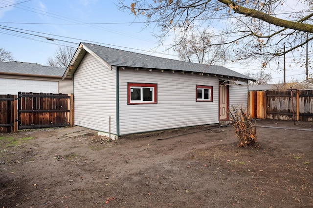 rear view of property featuring an outdoor structure