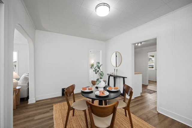 dining space featuring dark wood-type flooring