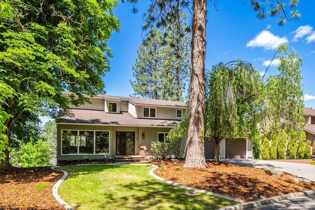 view of front property with a front lawn and a garage