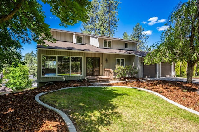 front of property with a garage and a front lawn