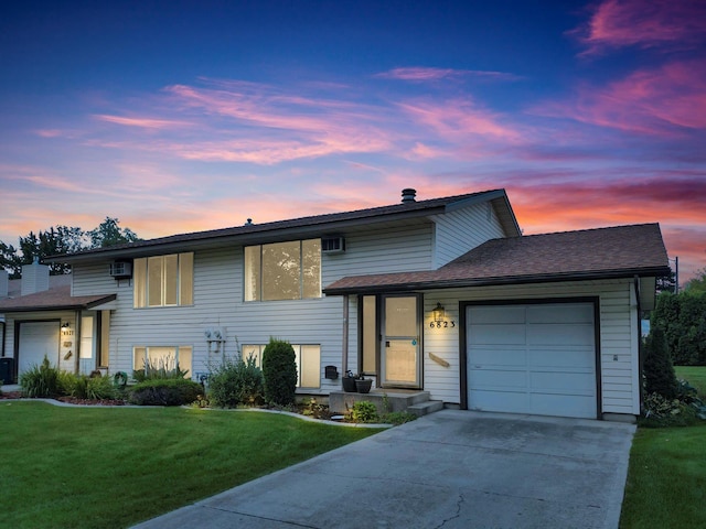 split level home with a lawn and a garage