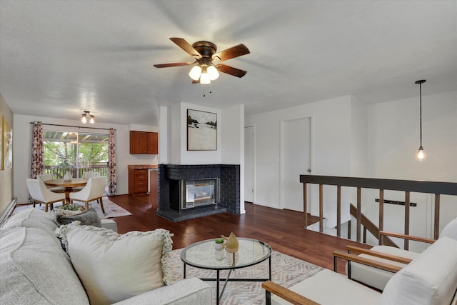 living room featuring ceiling fan and dark hardwood / wood-style flooring