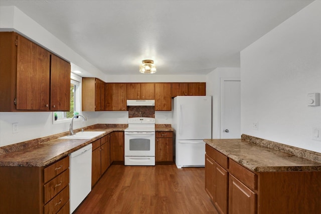 kitchen with white appliances, sink, and dark wood-type flooring