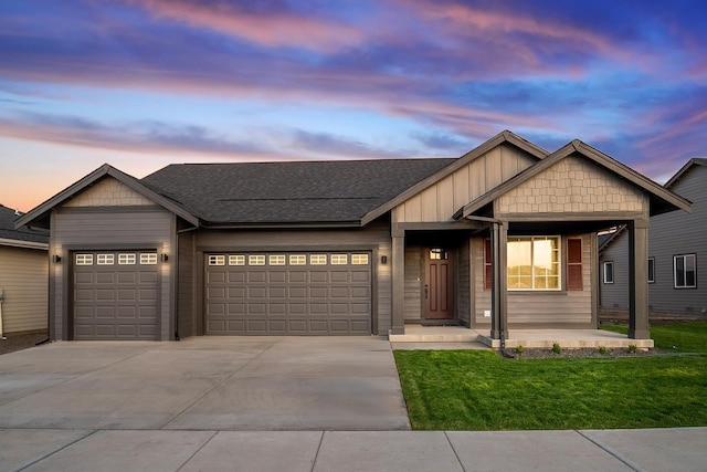 view of front facade with a yard and a garage