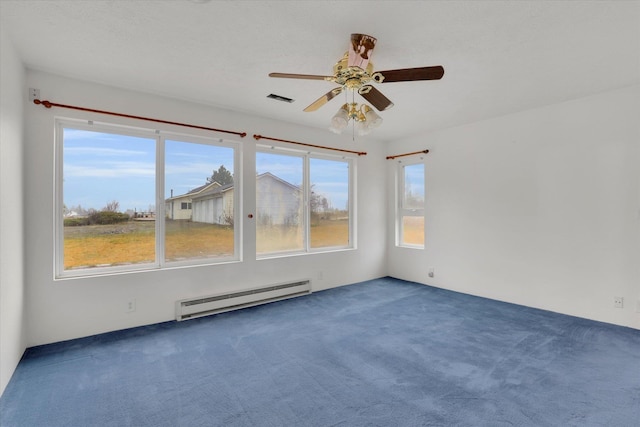 spare room with ceiling fan, dark carpet, and a baseboard heating unit