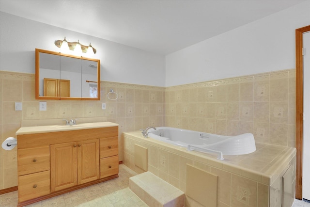 bathroom featuring vanity, tile walls, and tiled bath