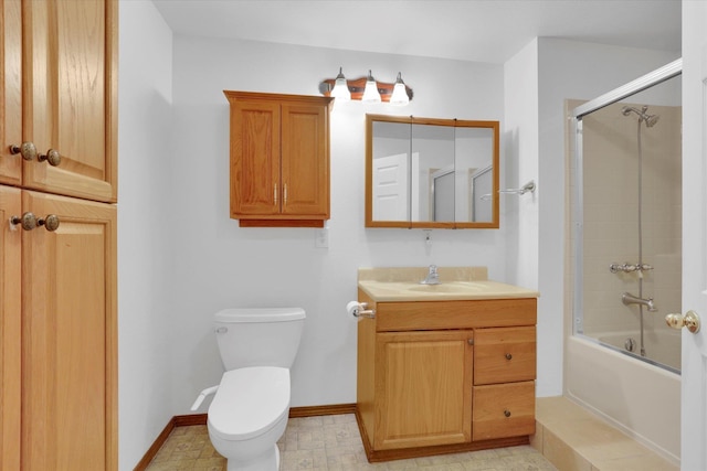 full bathroom featuring vanity, bath / shower combo with glass door, and toilet