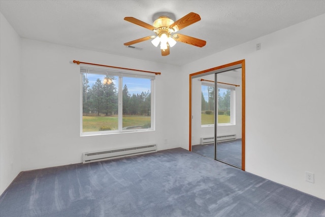 unfurnished room with ceiling fan, carpet, and a baseboard radiator