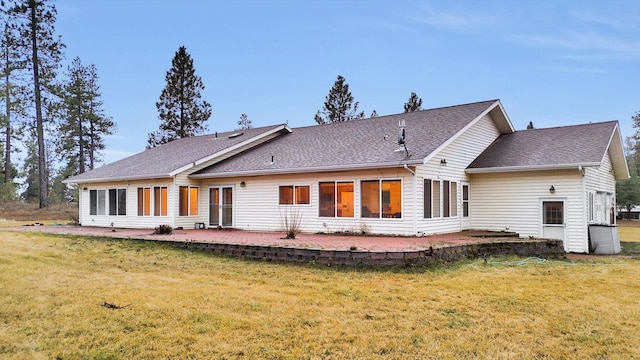 back of property featuring a yard and a patio