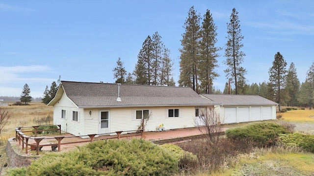 rear view of property with a garage