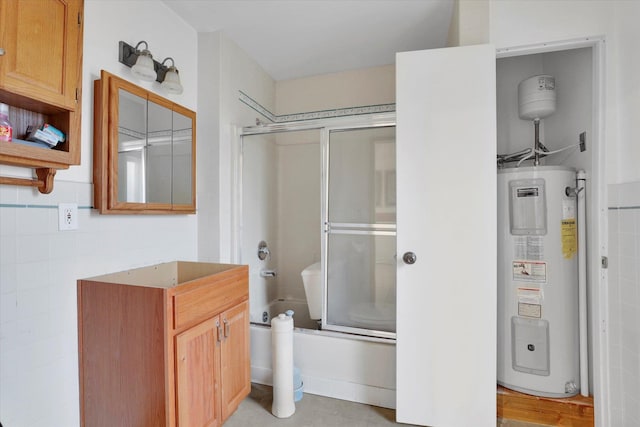 bathroom featuring combined bath / shower with glass door, toilet, and water heater