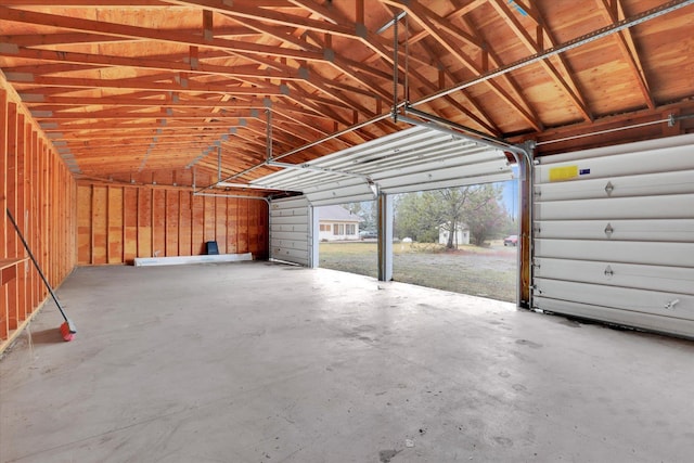 garage featuring a carport and wooden walls