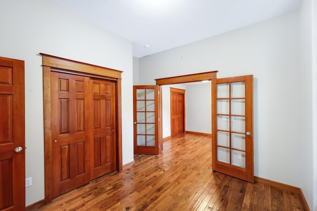 foyer with french doors and hardwood / wood-style flooring