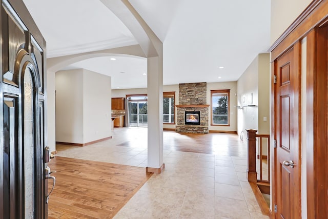 foyer with light tile patterned floors and a fireplace