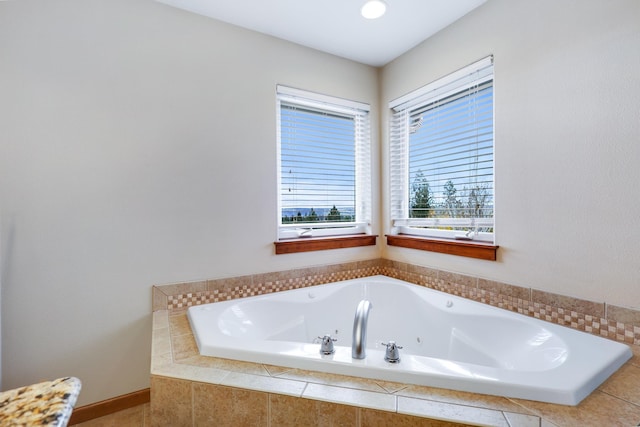 bathroom with a relaxing tiled tub