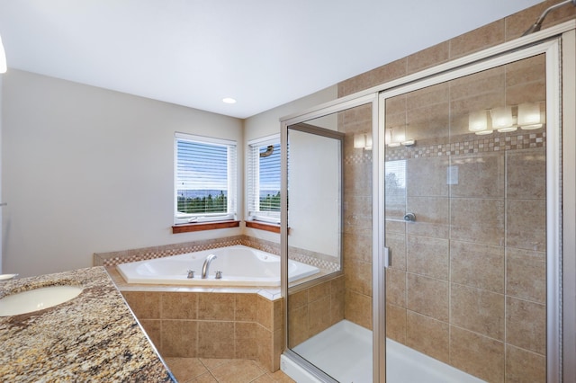 bathroom with tile patterned floors, vanity, and separate shower and tub