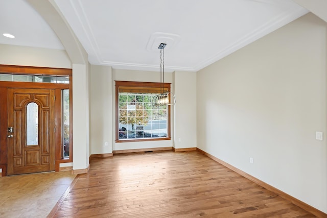 foyer entrance featuring light hardwood / wood-style flooring and a chandelier