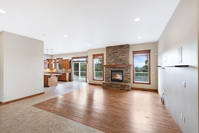 unfurnished living room featuring light hardwood / wood-style floors and a fireplace