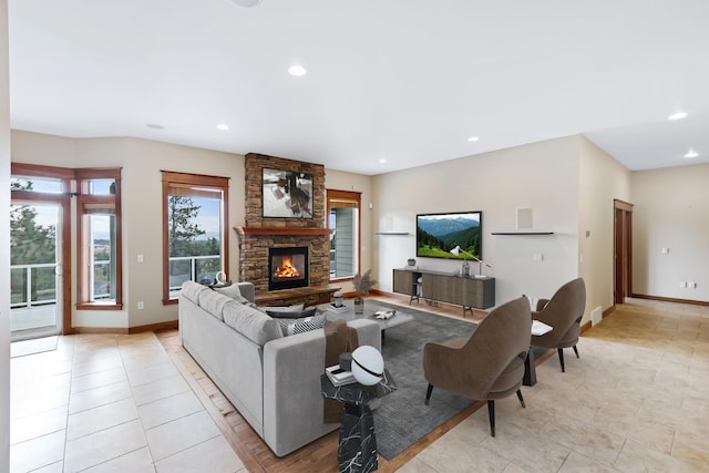 living room with a fireplace and light tile patterned flooring