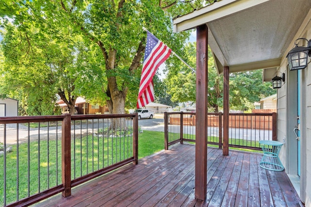 wooden deck featuring a yard