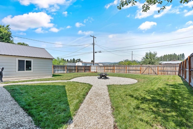 view of yard featuring an outdoor fire pit