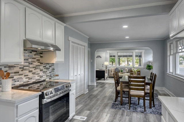 kitchen with white cabinetry, stainless steel electric stove, and ornamental molding