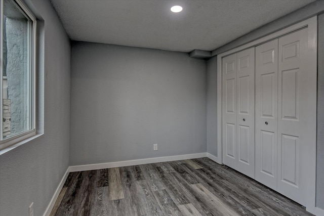 unfurnished bedroom featuring hardwood / wood-style flooring and a closet