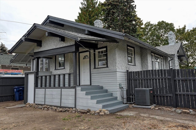 view of front facade with central AC unit and covered porch