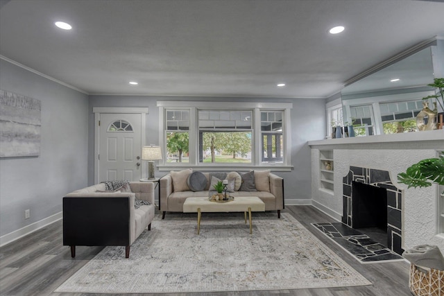 living room with crown molding, dark hardwood / wood-style floors, and a fireplace