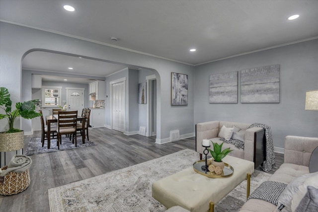 living room with crown molding and hardwood / wood-style floors