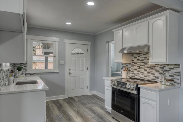 kitchen with ornamental molding, stainless steel electric stove, sink, and white cabinets