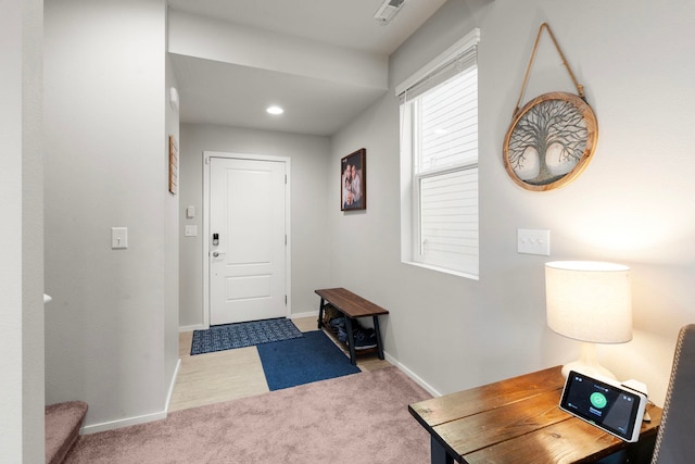 entryway featuring light carpet