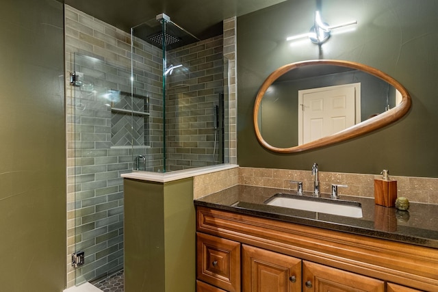 bathroom featuring vanity and an enclosed shower