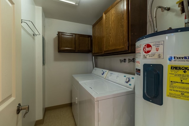 laundry room with cabinets, washing machine and dryer, and water heater