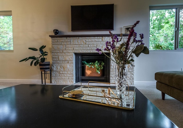 living room with a healthy amount of sunlight and a fireplace