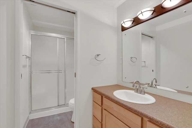 bathroom featuring hardwood / wood-style flooring, toilet, vanity, and walk in shower