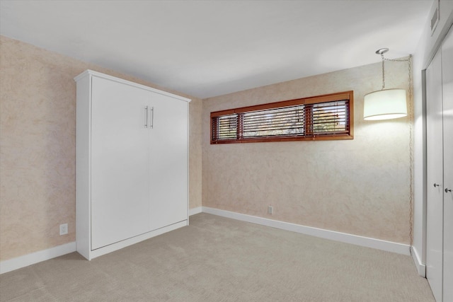 empty room with light colored carpet