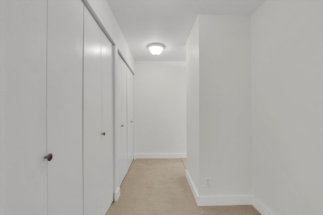 hallway with light colored carpet