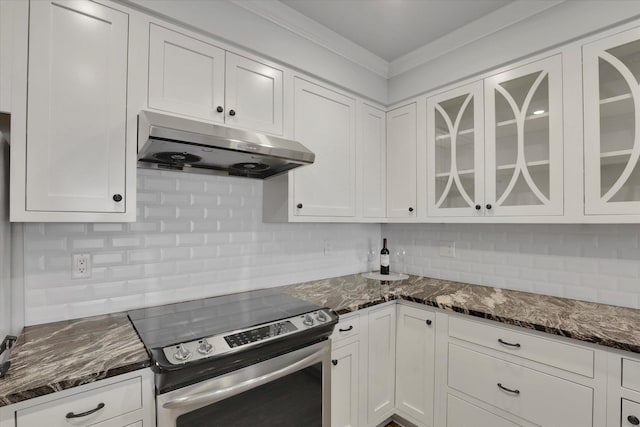 kitchen featuring white cabinetry, dark stone countertops, crown molding, stainless steel electric stove, and decorative backsplash